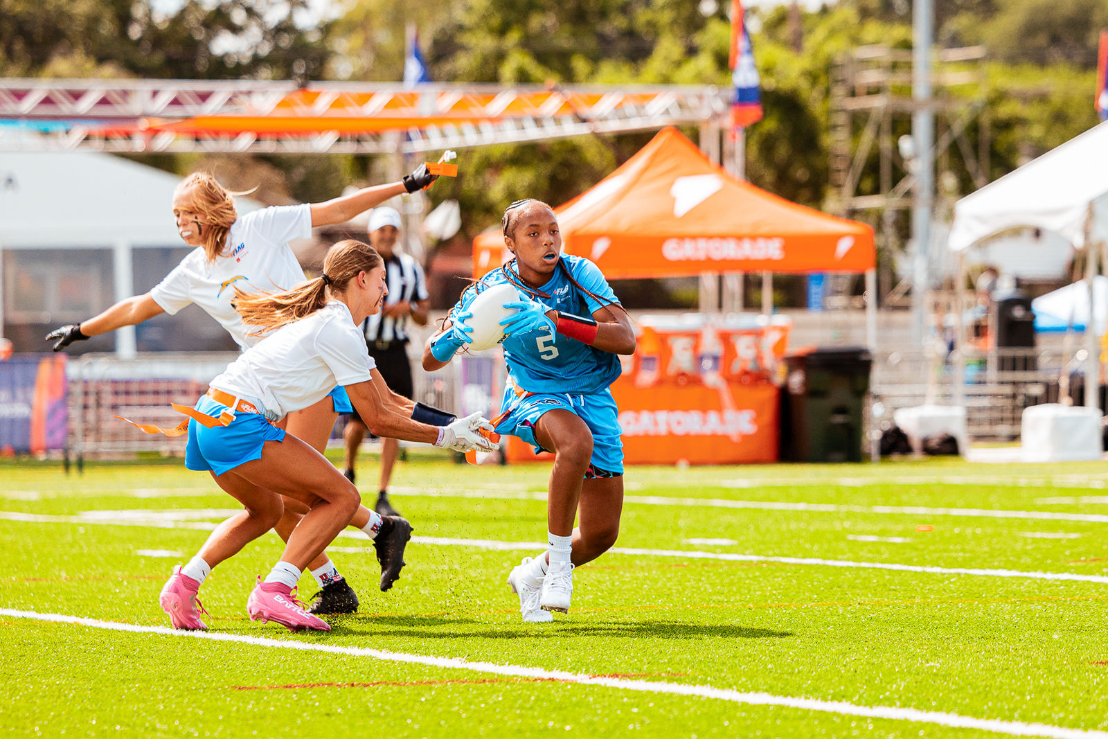A flag football player in a blue jersey leaps to make a catch during the 2026 NFL FLAG Championships