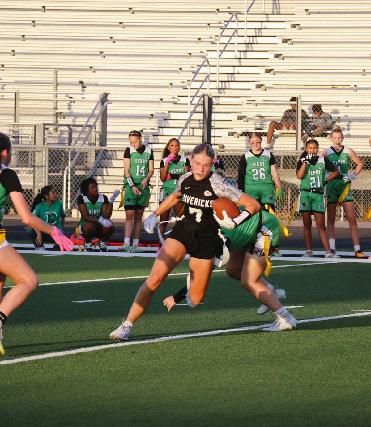 Kansas high school girls flag football player running with the ball during the state’s first sanctioned season